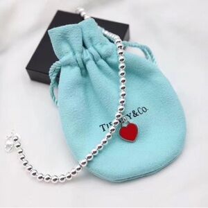 Tiffany & Co. Silver Bracelet with Red Heart Charm